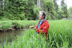 Brian McTeague, Natural Resources Quantitative Services Manager for the Squaxin Island Tribe, notes the location of knotweed along Skookum Creek.